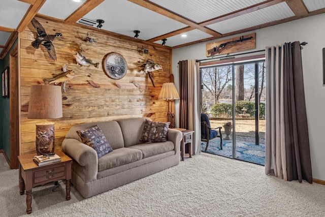 living room with beamed ceiling, coffered ceiling, carpet flooring, and wood walls