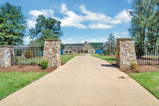 view of gate featuring a yard