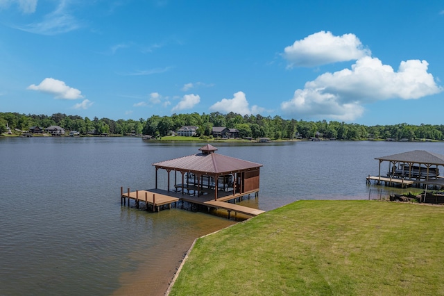 view of dock featuring a lawn and a water view