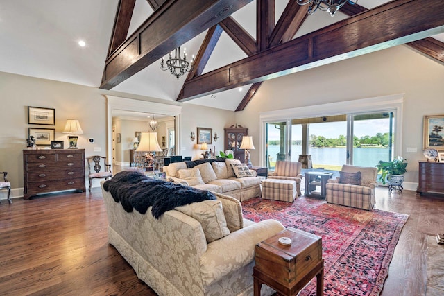 living room featuring a water view, an inviting chandelier, high vaulted ceiling, dark hardwood / wood-style flooring, and beam ceiling