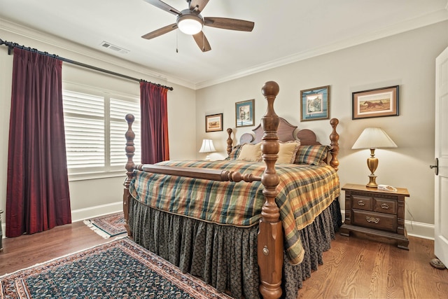 bedroom featuring wood-type flooring, ornamental molding, and ceiling fan