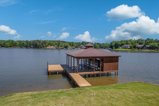 dock area featuring a water view and a lawn