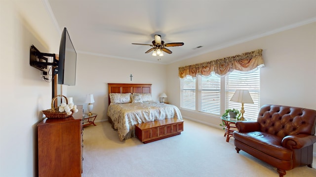 bedroom featuring ornamental molding, light colored carpet, and ceiling fan