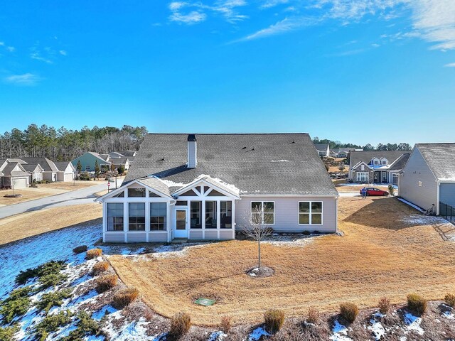 back of house with a sunroom