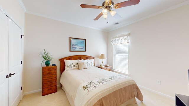 bedroom featuring crown molding, a closet, ceiling fan, and light carpet