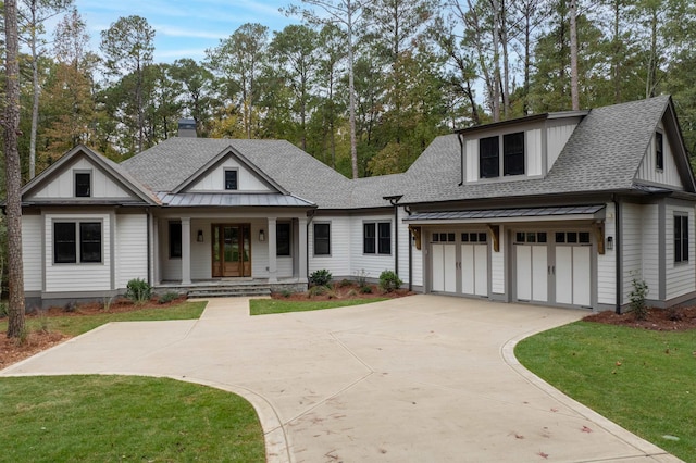 view of front facade featuring a porch, a garage, and a front lawn