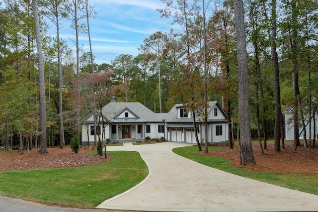 view of front of property with a garage and a front lawn