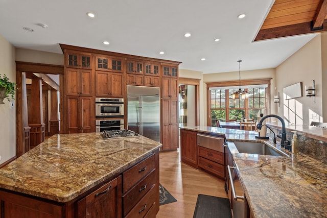 1611 Pine Grove Rd, Greensboro, GA 30642 - kitchen with a large island, sink, pendant lighting, stainless steel appliances, and dark stone counters