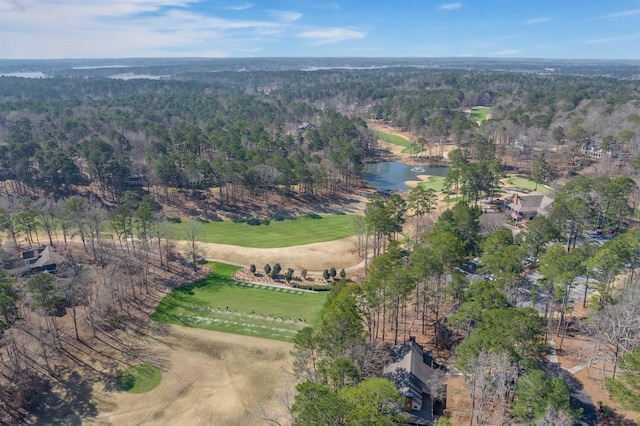 drone / aerial view featuring a wooded view, a rural view, and a water view