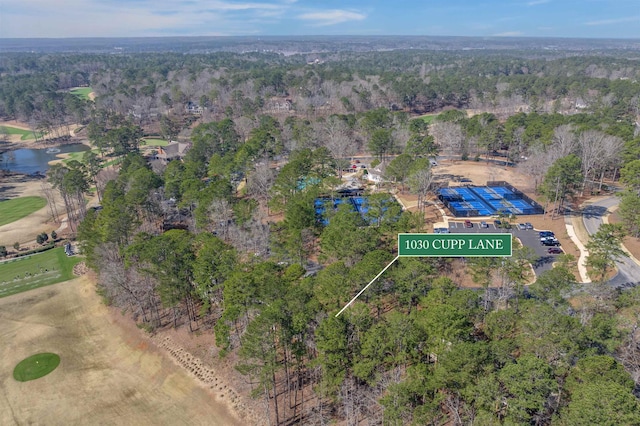 drone / aerial view featuring a water view and a view of trees