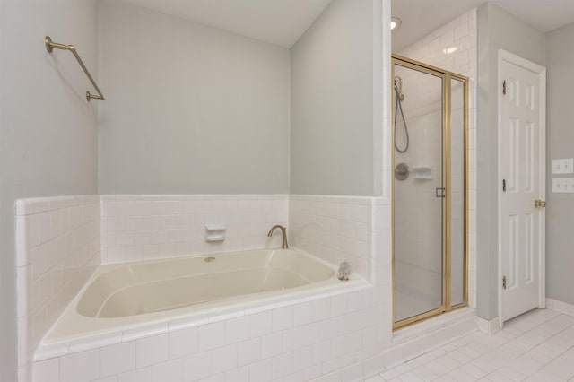 full bathroom with a bath, a shower stall, and tile patterned flooring