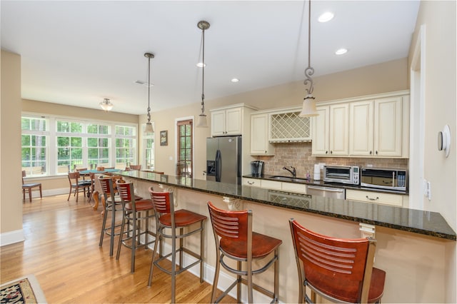 1051 Swift Crk, Greensboro, GA 30642 - kitchen with stainless steel appliances, light wood-style floors, tasteful backsplash, a sink, and recessed lighting