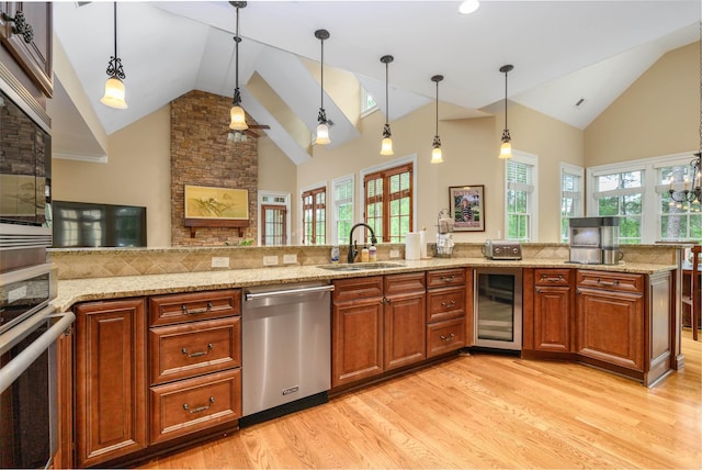 1051 Swift Crk, Greensboro, GA 30642 - kitchen featuring appliances with stainless steel finishes, wine cooler, high vaulted ceiling, a sink, and light wood-style floors