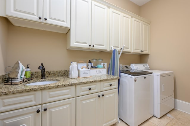 1051 Swift Crk, Greensboro, GA 30642 - laundry room with cabinet space, washer and clothes dryer, light tile patterned floors, and baseboards