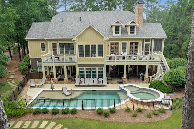 1051 Swift Crk, Greensboro, GA 30642 - back of house featuring a fenced backyard, a chimney, stairs, and board and batten siding