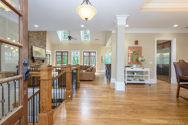 1051 Swift Crk, Greensboro, GA 30642 - corridor featuring an upstairs landing, light wood finished floors, ornamental molding, a skylight, and baseboards