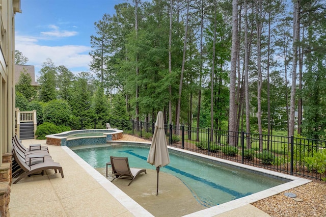 1051 Swift Crk, Greensboro, GA 30642 - view of swimming pool with a pool with connected hot tub, a patio area, and view of wooded area