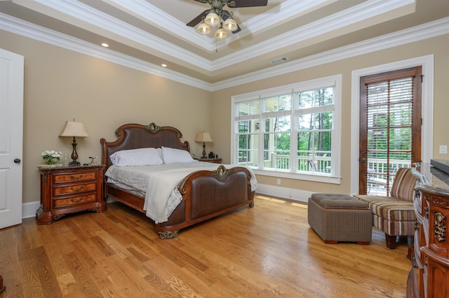 1051 Swift Crk, Greensboro, GA 30642 - bedroom with multiple windows, access to exterior, ornamental molding, light wood-type flooring, and a raised ceiling