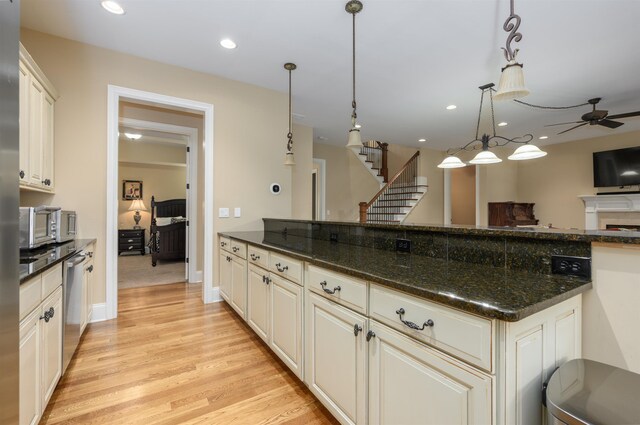 1051 Swift Crk, Greensboro, GA 30642 - kitchen featuring dishwasher, ceiling fan, light wood-type flooring, open floor plan, and hanging light fixtures