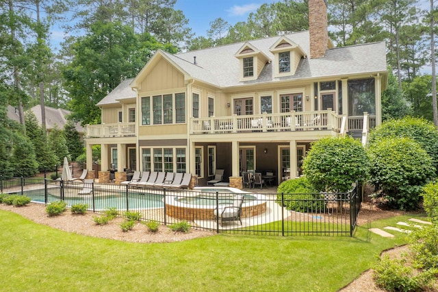 1051 Swift Crk, Greensboro, GA 30642 - rear view of property featuring a patio, a chimney, a sunroom, an outdoor living space, and a shingled roof