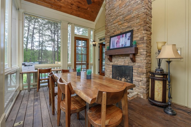 1051 Swift Crk, Greensboro, GA 30642 - dining space featuring hardwood / wood-style floors, lofted ceiling, and a fireplace