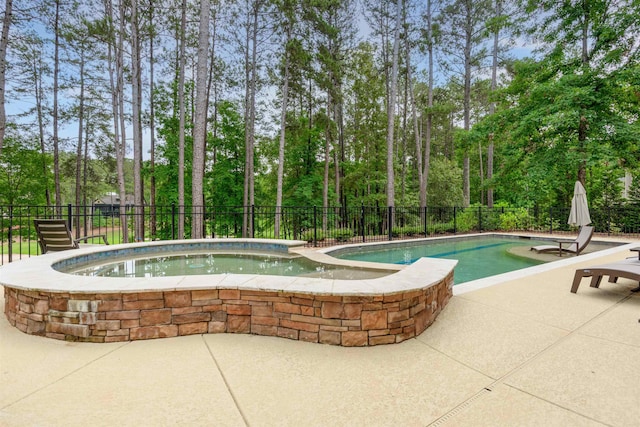 1051 Swift Crk, Greensboro, GA 30642 - view of swimming pool featuring a patio, view of wooded area, and a pool with connected hot tub