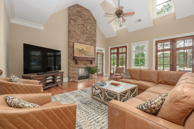 1051 Swift Crk, Greensboro, GA 30642 - living area featuring ceiling fan, high vaulted ceiling, wood finished floors, a fireplace, and french doors