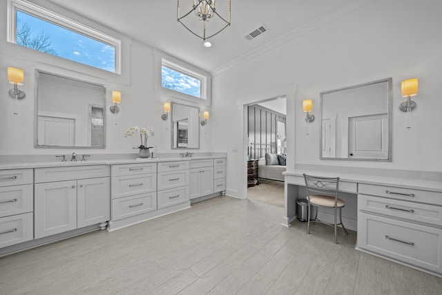 full bath with wood finished floors, visible vents, a sink, and double vanity