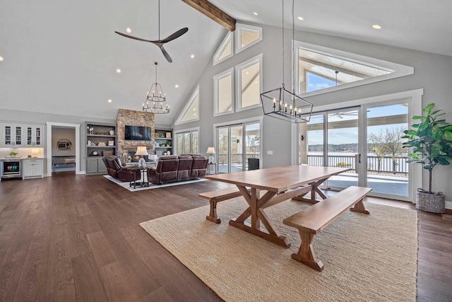 dining area featuring a chandelier, a healthy amount of sunlight, and dark wood finished floors