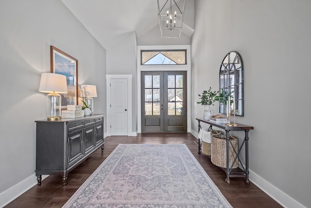 entryway with baseboards, french doors, dark wood-type flooring, and a notable chandelier