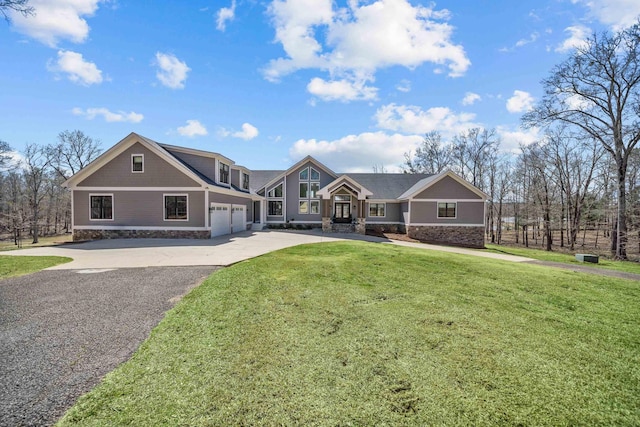 view of front facade featuring an attached garage, driveway, stone siding, and a front yard