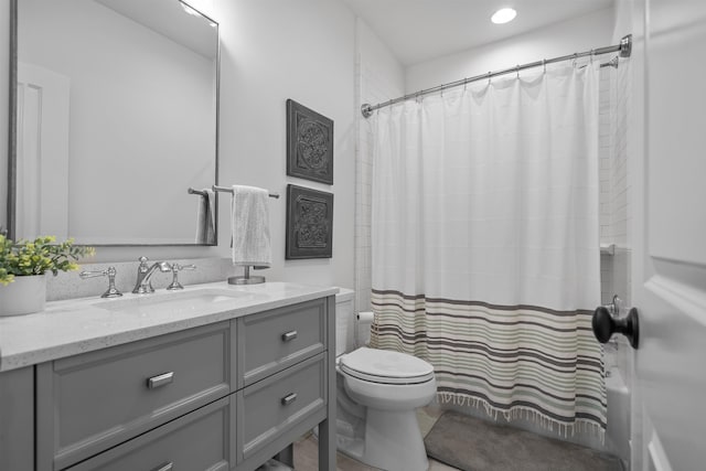 bathroom featuring vanity, toilet, and shower / tub combo with curtain