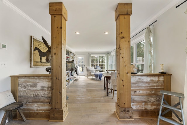 hall with decorative columns, ornamental molding, wood finished floors, and recessed lighting