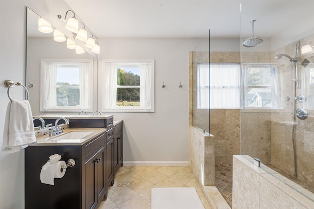 bathroom with tile patterned flooring, baseboards, a walk in shower, and vanity