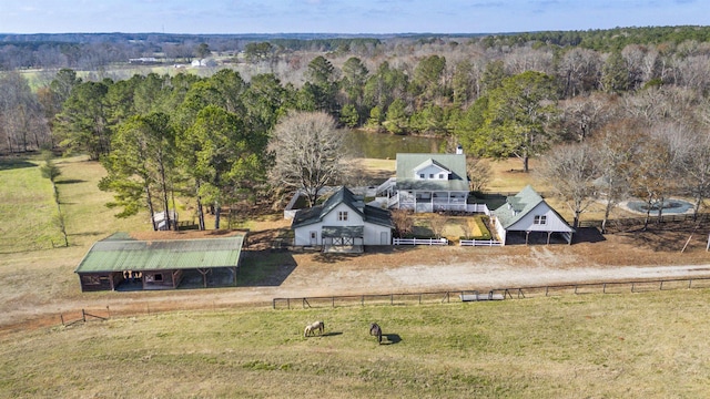 drone / aerial view featuring a rural view and a wooded view