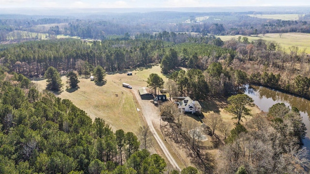 drone / aerial view featuring a forest view and a water view