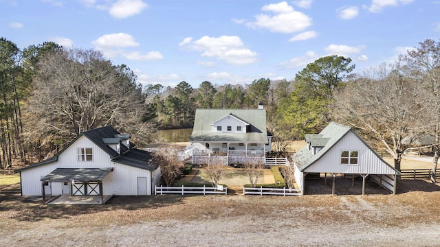 back of house with an outbuilding, a barn, and fence