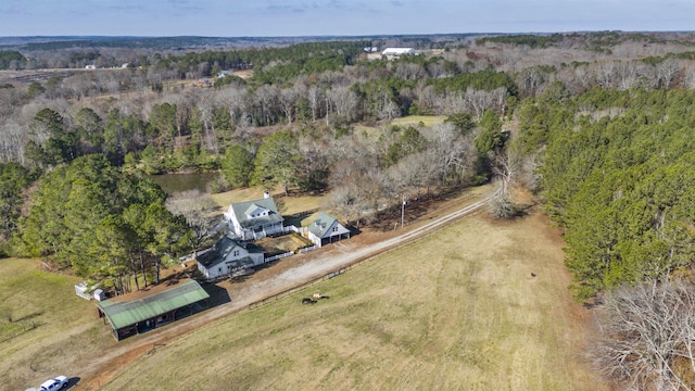 bird's eye view featuring a forest view and a rural view