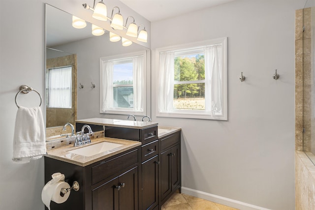 full bathroom featuring a wealth of natural light, vanity, baseboards, and tile patterned floors