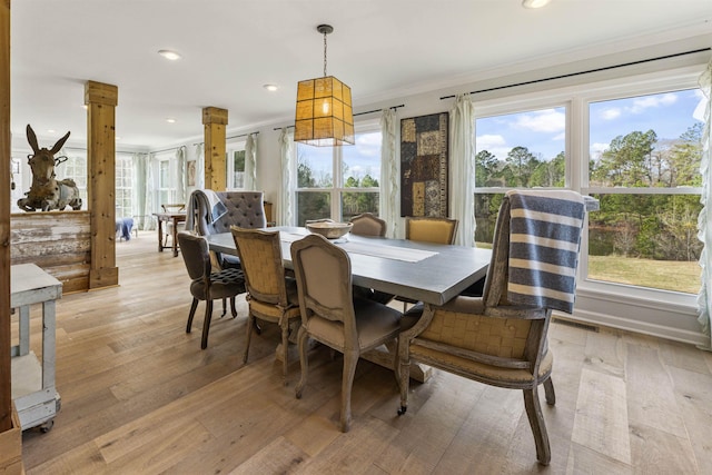 dining room with light wood-type flooring, ornate columns, ornamental molding, and recessed lighting