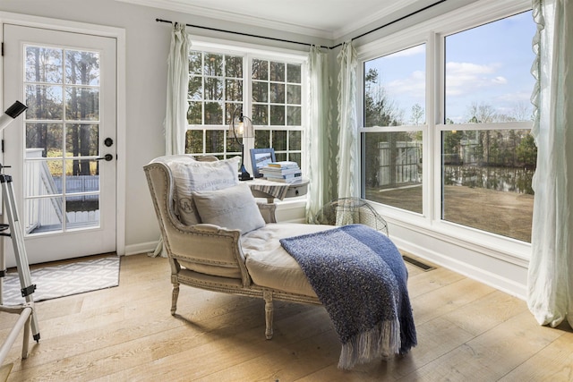 sunroom / solarium featuring a healthy amount of sunlight and visible vents