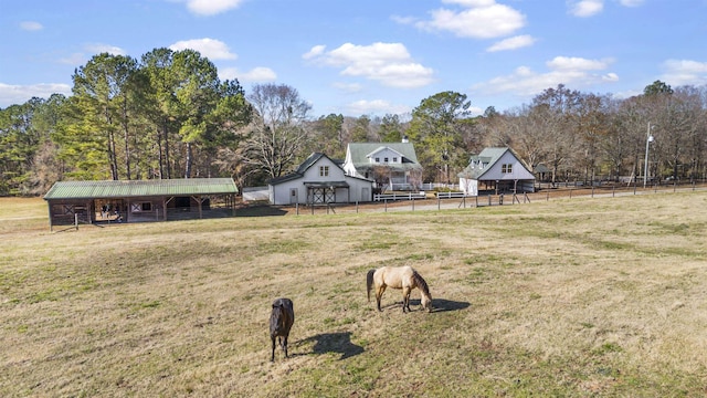 view of yard with a pole building, an outdoor structure, and an exterior structure