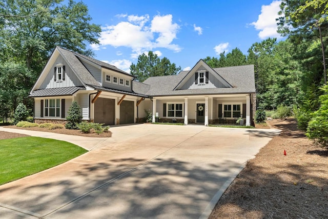 178 Parkside Ln, Eatonton, GA 31024 - modern inspired farmhouse with covered porch, driveway, a standing seam roof, roof with shingles, and stone siding