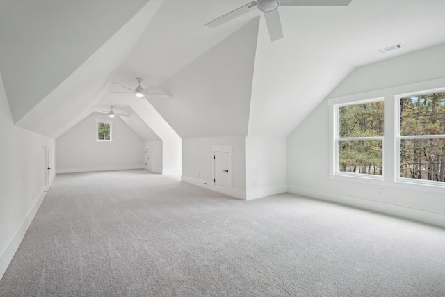 additional living space with visible vents, baseboards, ceiling fan, lofted ceiling, and carpet flooring