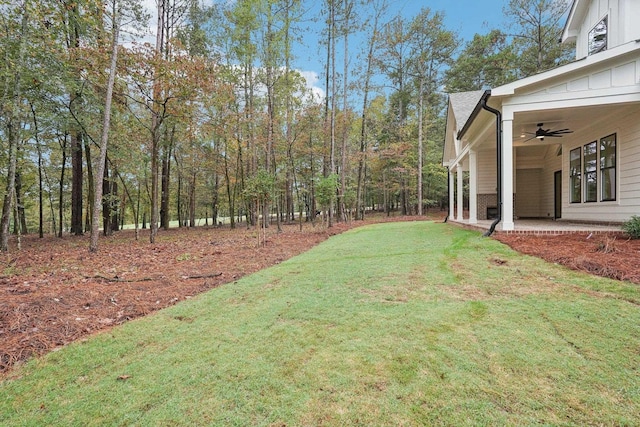 view of yard with a patio and ceiling fan