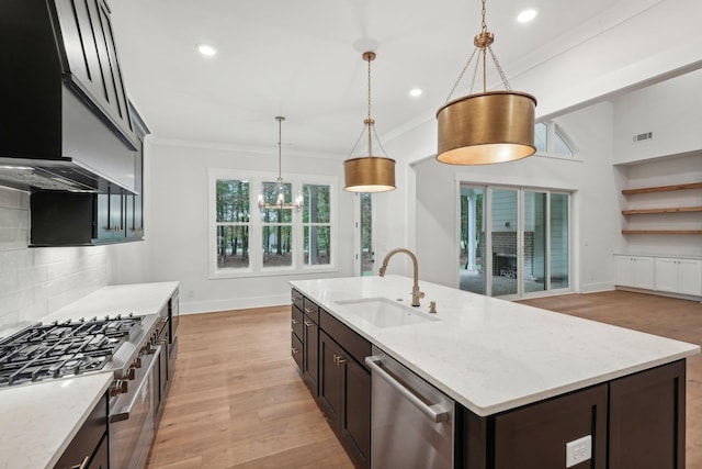 kitchen with decorative backsplash, ornamental molding, stainless steel appliances, and a sink