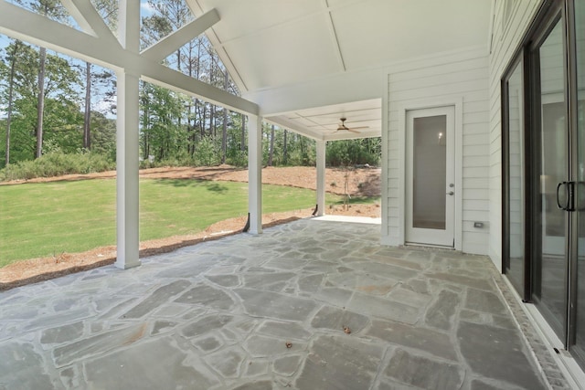 unfurnished sunroom with ceiling fan