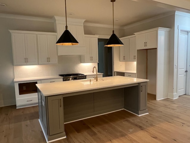 kitchen featuring white cabinetry, crown molding, range, and backsplash