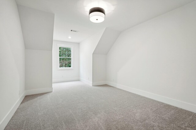 bonus room with visible vents, carpet, baseboards, and lofted ceiling