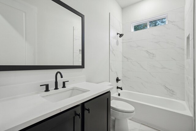 bathroom with washtub / shower combination, toilet, marble finish floor, and vanity